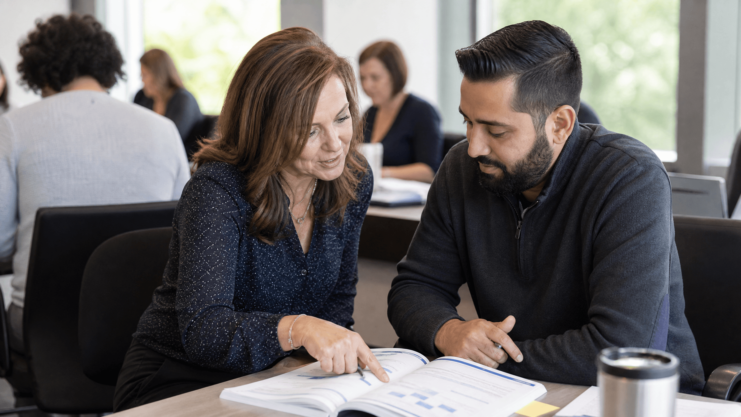 Facilitator coaching a new manager one on one